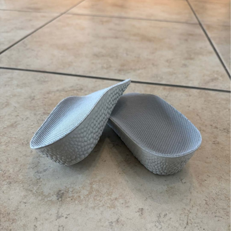 pair of Inchmaxxers 2.0 - Height Increasing Insoles on tiled floor